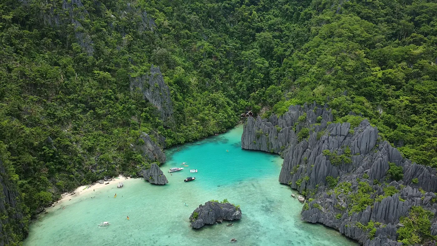 Aerial of a sheltered lagoon ringed by jagged limestone spires, Palawan